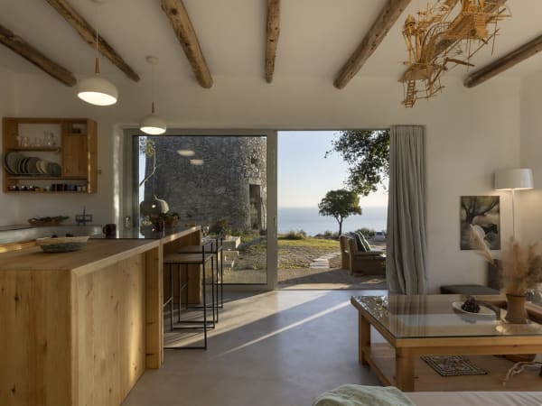 The living area, the kitchen and a wall of sliding glass doors.